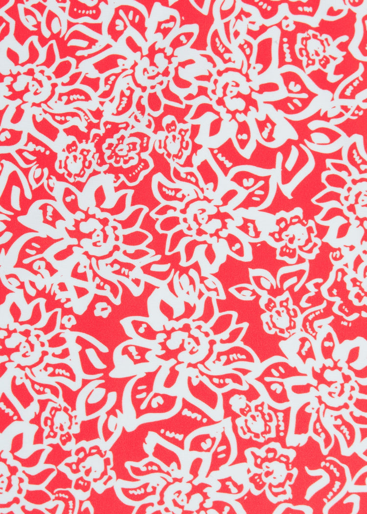 A fabric close-up of the red-orange and white floral print on the Cabana Life sun protective Americana Sleeveless Tunic Dress.