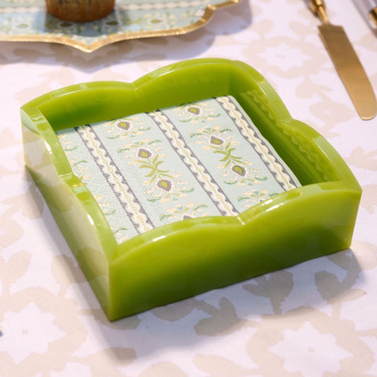 Green acrylic napkin holder on a patterned dining table