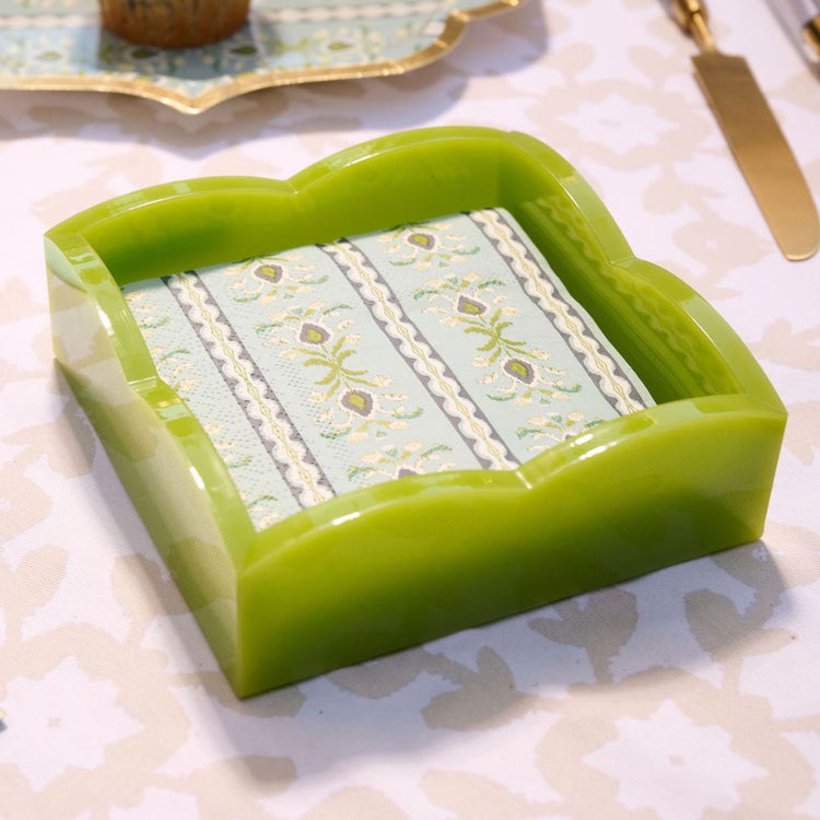 Green acrylic napkin holder on a patterned dining table