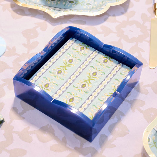 Blue napkin holder on a patterned dining table