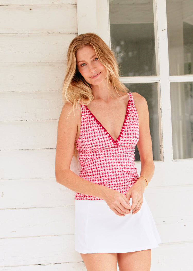 Woman wearing Coral Gables Reversible Embroidered Tankini Top and white classic swim skirt.