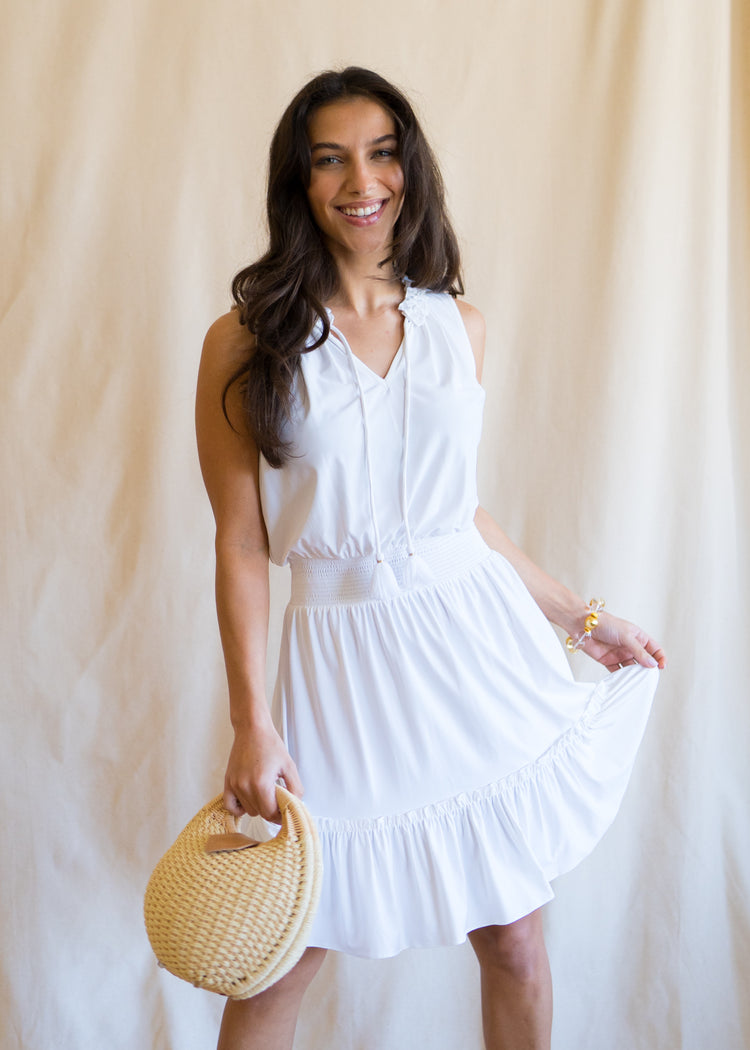 Woman wearing White Sleeveless Ruffle Dress