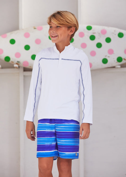 Boy wearing the blue Cabana Life sun protective San Sebastian Stripe Boys Swim Trunk. 