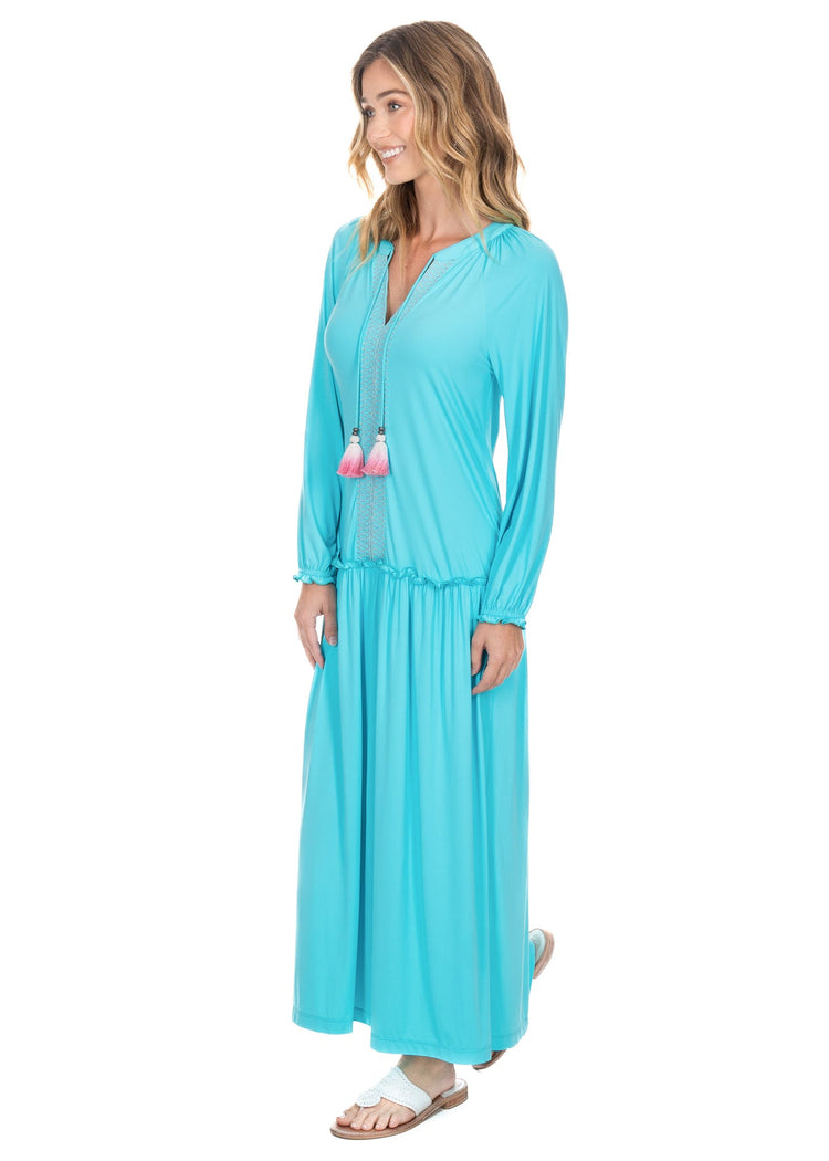 The side view of a woman wearing the sun protective Cabana Life Aqua Embroidered Tunic Maxi Dress. 