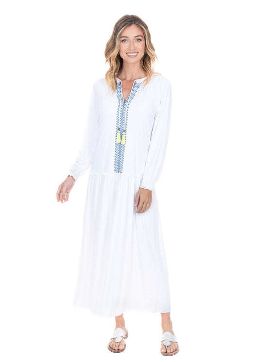A front facing studio shot of a woman wearing the UPF50+ Cabana Life White Embroidered Tunic Maxi Dress highlighting the flowing hem and fun yellow tassles. 