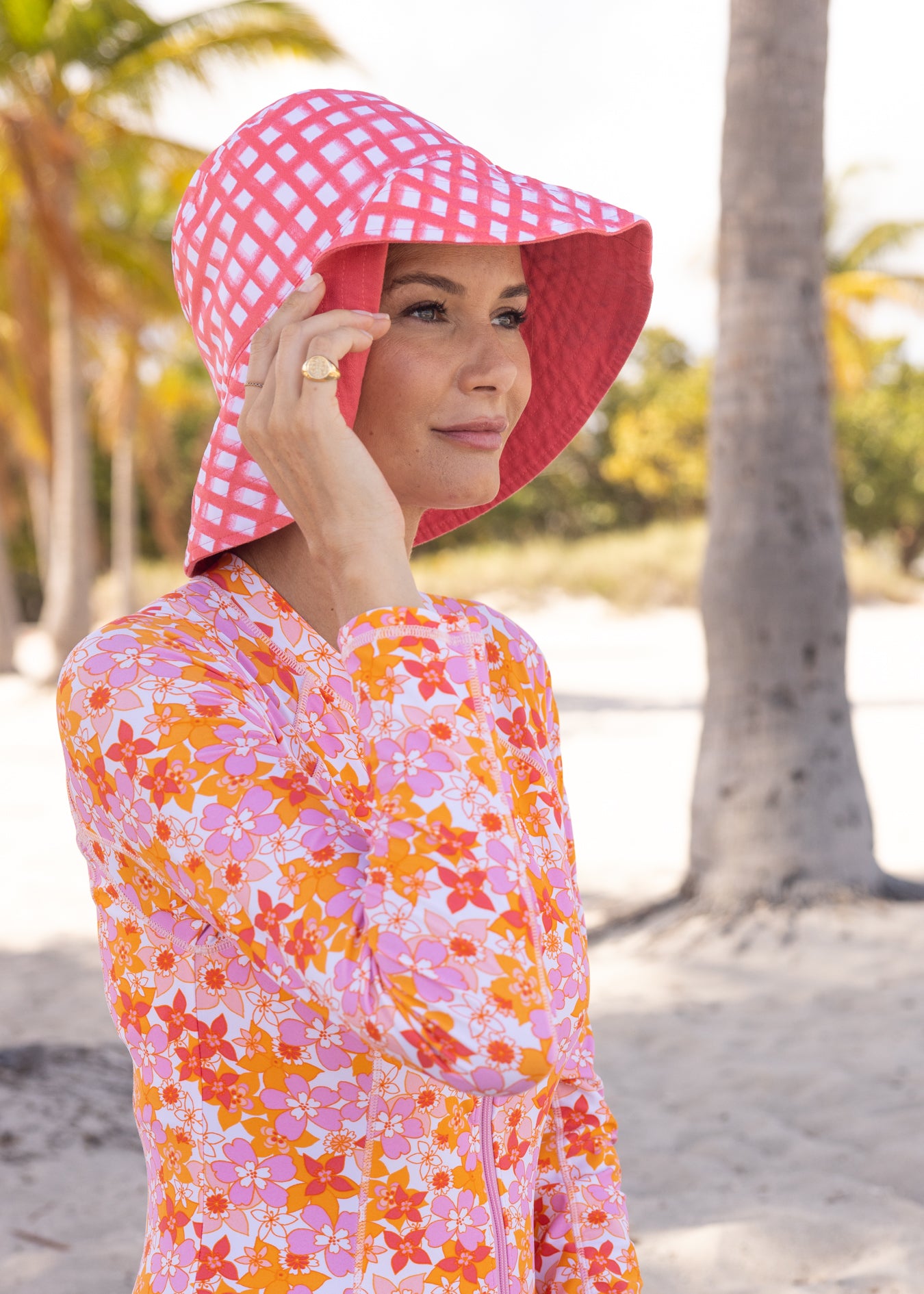 Woman wearing Nantucket/Coral Reversible Bucket Hat and Surfside Unisuit