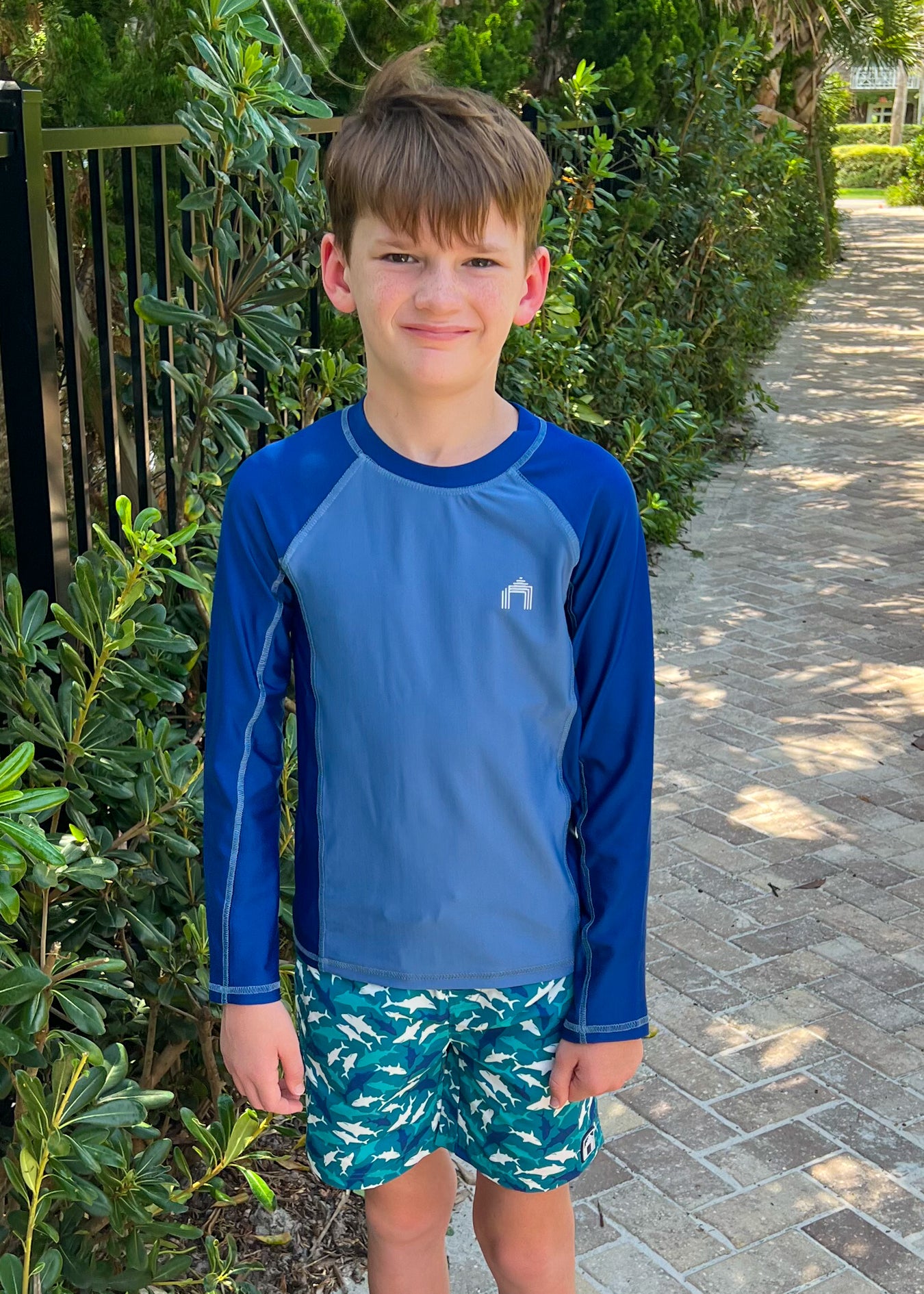 Boy wearing Blue Long Sleeve Rashguard and Shark Swim Trunks