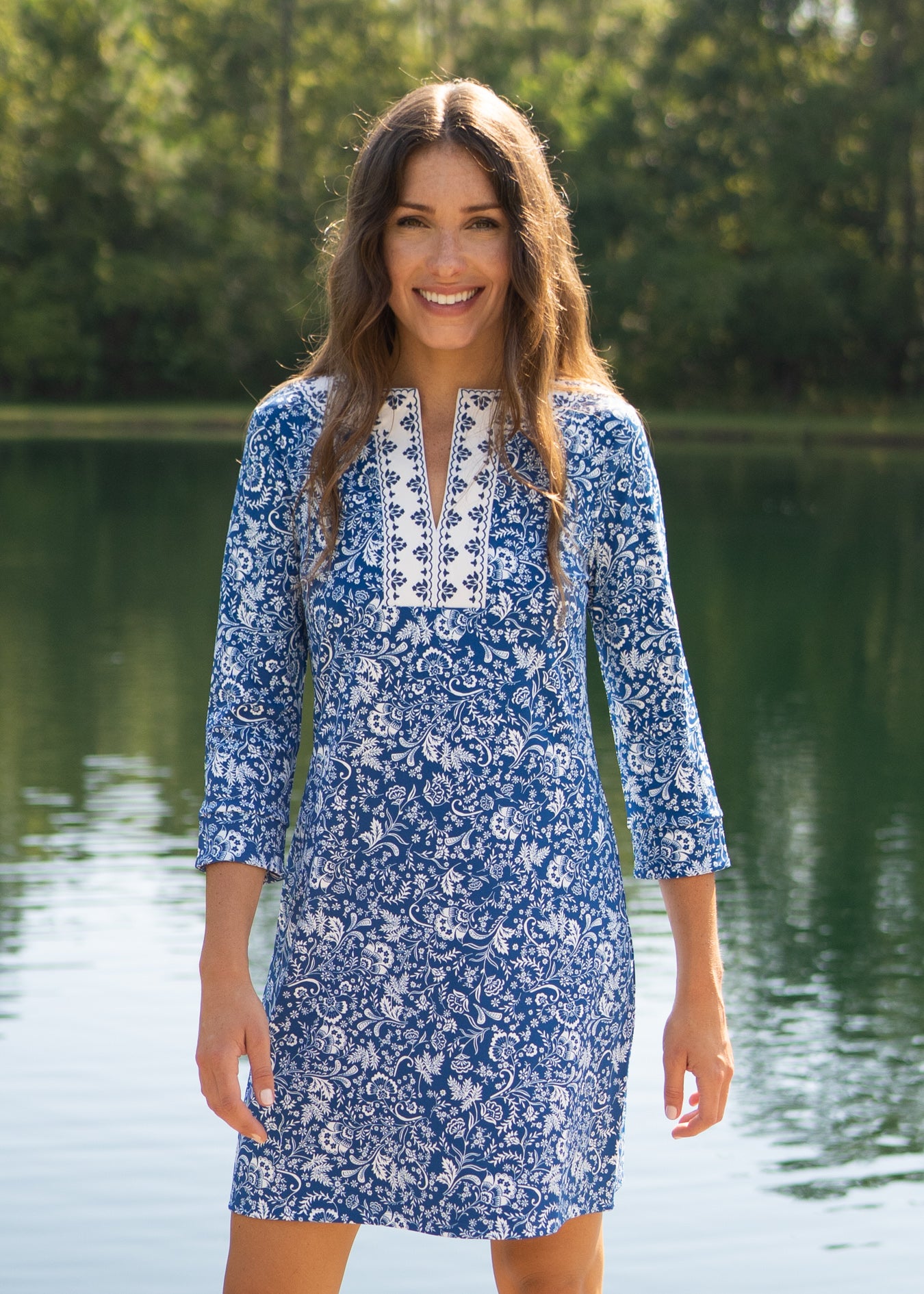 Woman wearing Aspen Embroidered Tunic Dress by a pond
