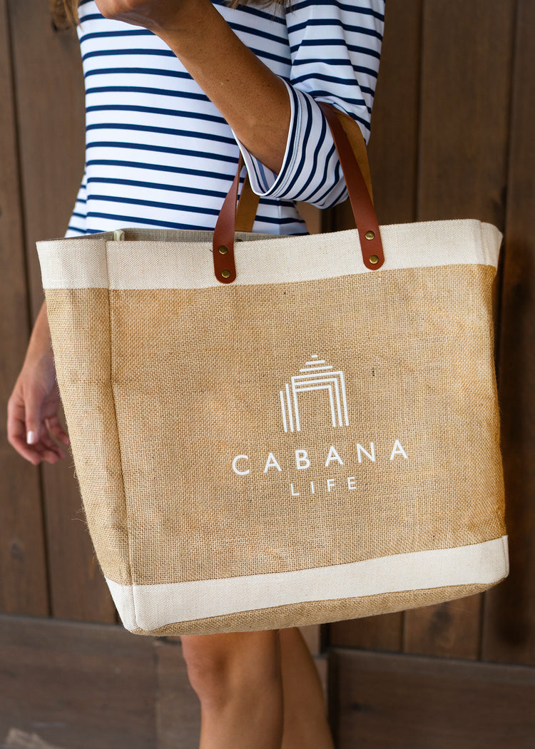 Woman holding White Cabana Life Beach Bag