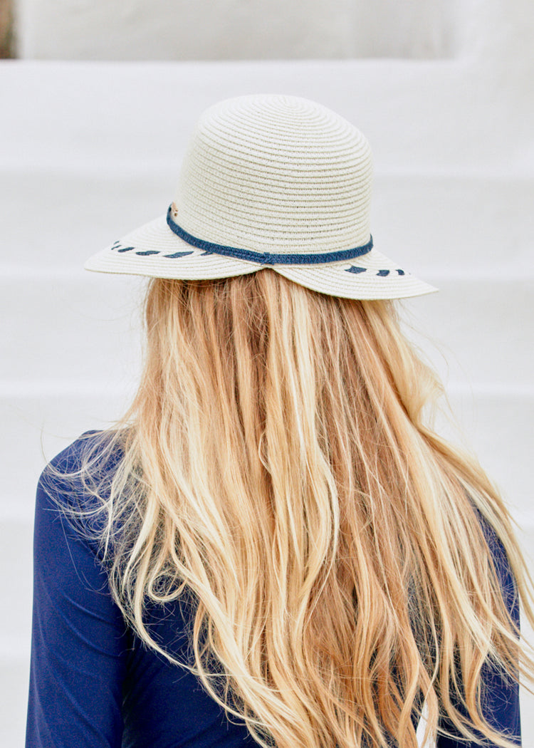Woman wearing Cream Backless Sun Hat with Navy Unisuit