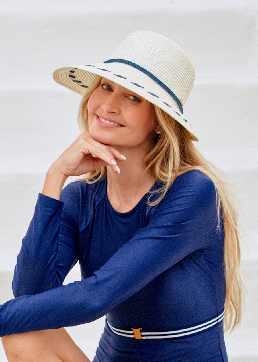 Woman wearing Cream Backless Sun Hat with Navy Unisuit