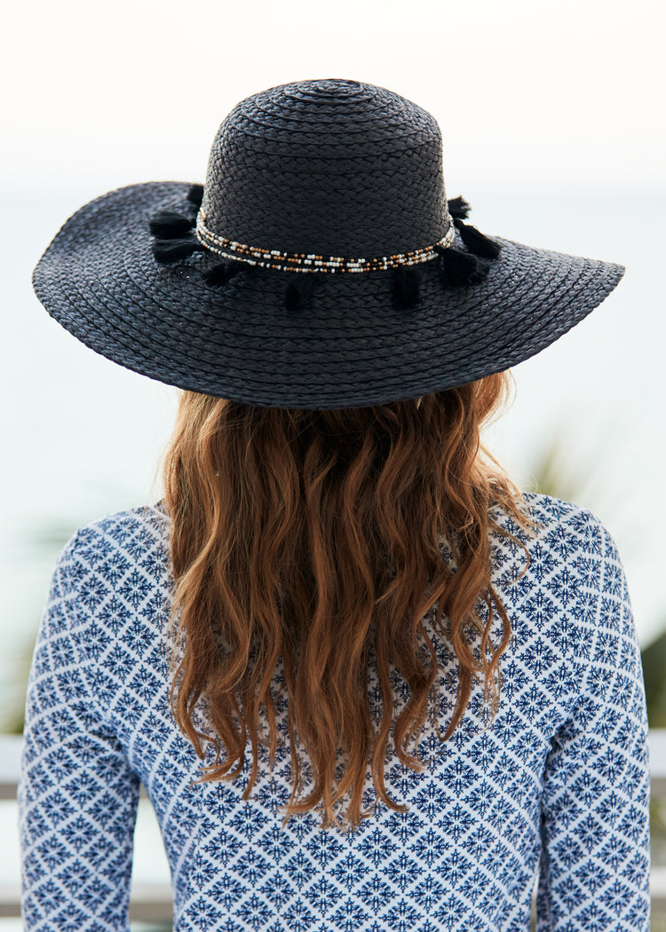 Woman wearing Black Wide Brim Sun Hat.