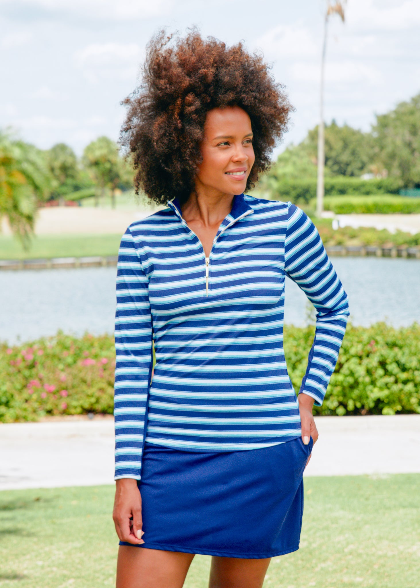 Woman wearing Cabana Life Delray Sport Zip Polo and Navy 17" Skort on golf course