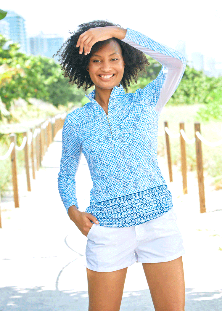 Woman wearing Sag Harbor Sport Zip Polo with White Microfiber Shorts