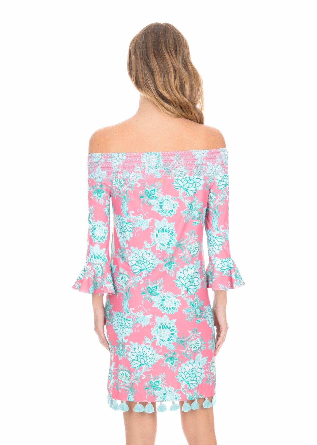 A blonde woman turned around wearing a Cote D`Azur Off The Shoulder Dress.