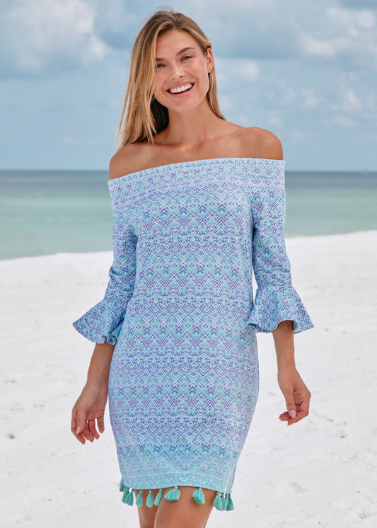 Woman on beach wearing Naples off the shoulder dress.