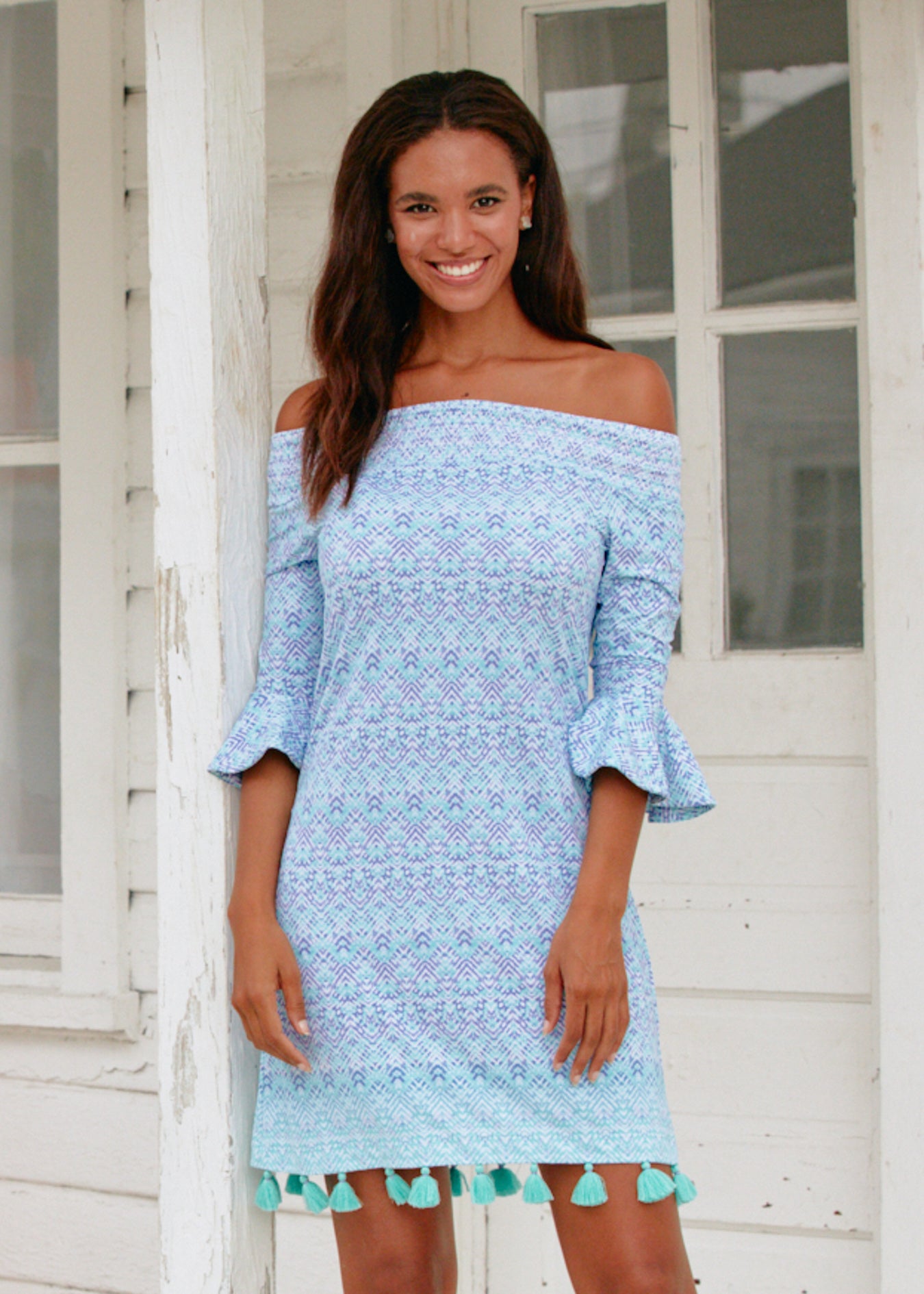 Woman wearing Naples off the shoulder dress.
