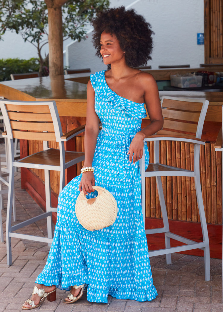 Woman holding purse wearing Palm Valley One Shoulder Maxi Dress.