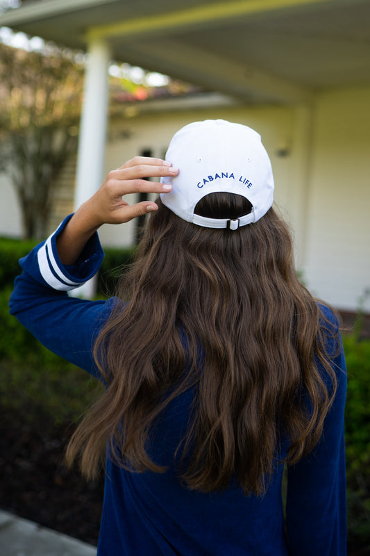 Woman wearing White Cabana Life Baseball Hat and Navy/White Terry Tunic