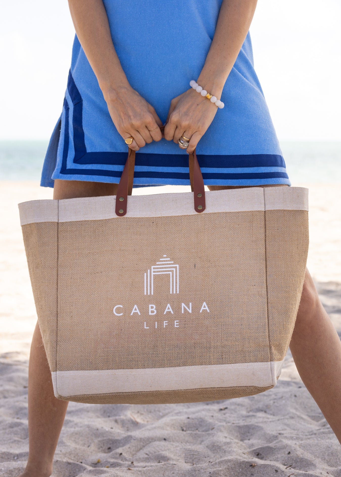 Woman holding White Cabana Life Beach Bag