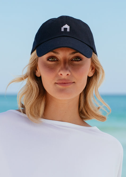 Woman wearing Navy Cabana Life Baseball Hat on beach.
